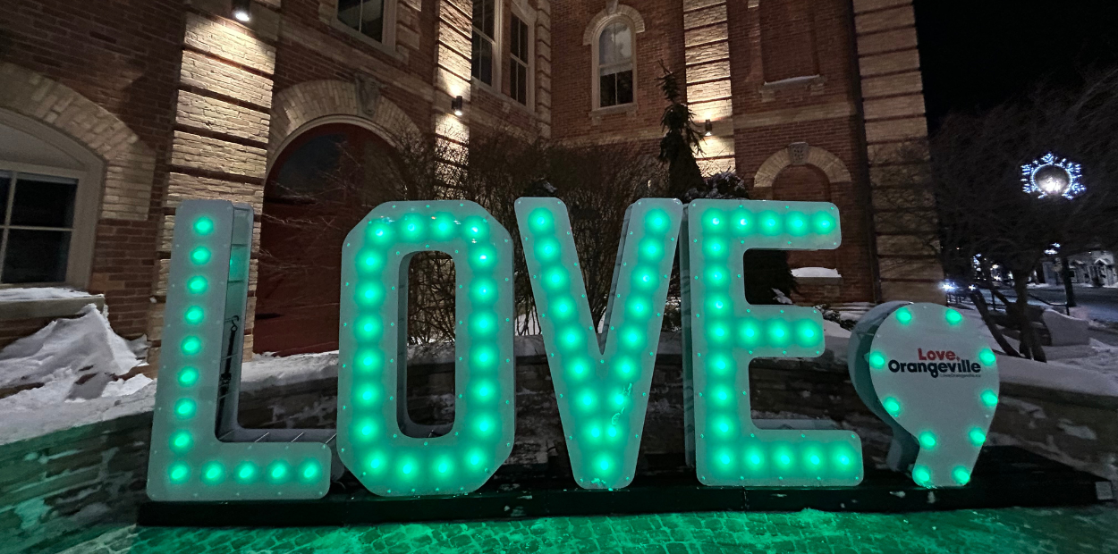 An illuminated marquee sign that spells LOVE